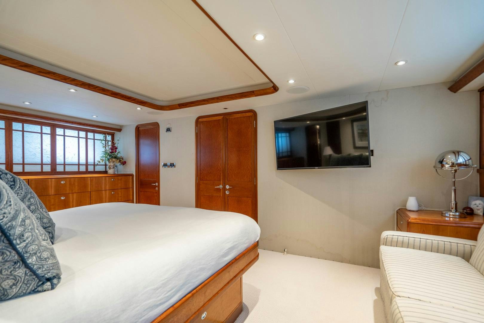 a bedroom with a bed and a television aboard LEGACY Yacht for Sale