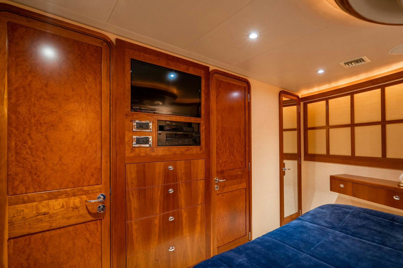 a room with a bed and a closet aboard LEGACY Yacht for Sale
