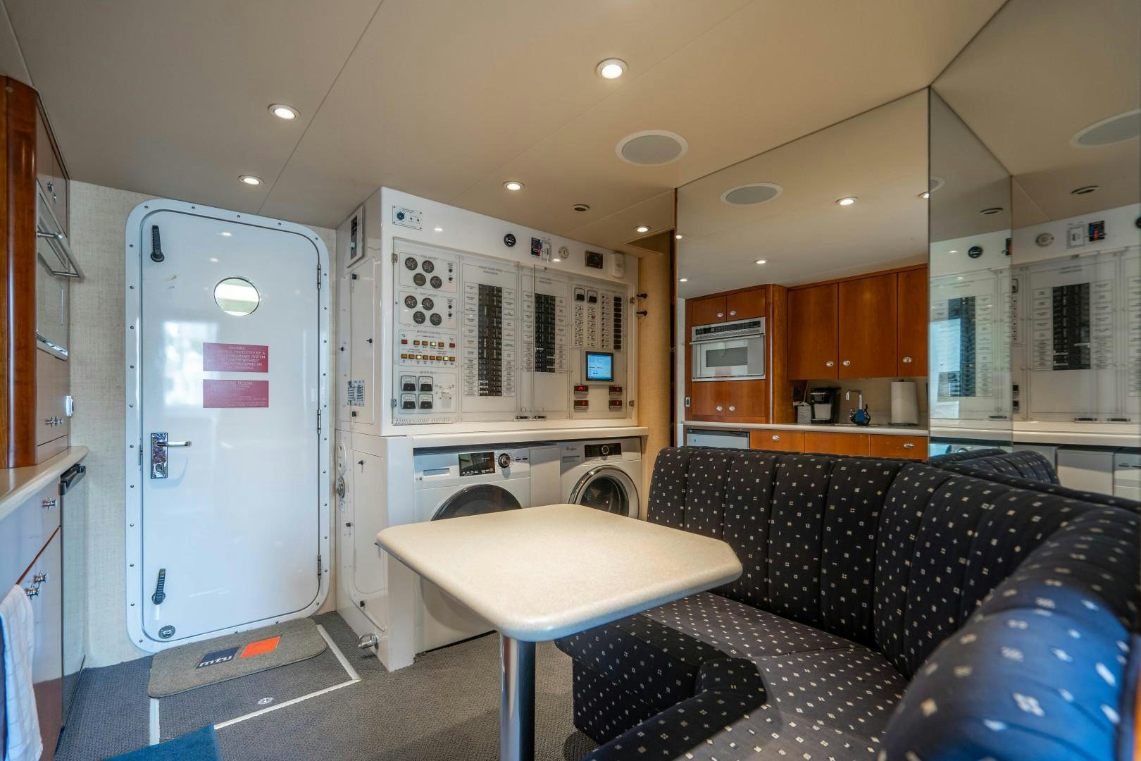 a living room with a couch and a table aboard LEGACY Yacht for Sale