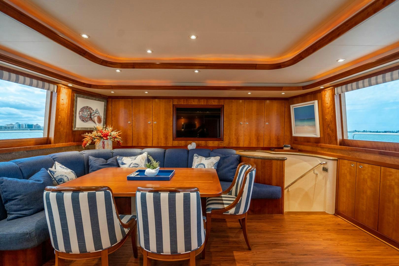 a living room with a couch and a table aboard LEGACY Yacht for Sale