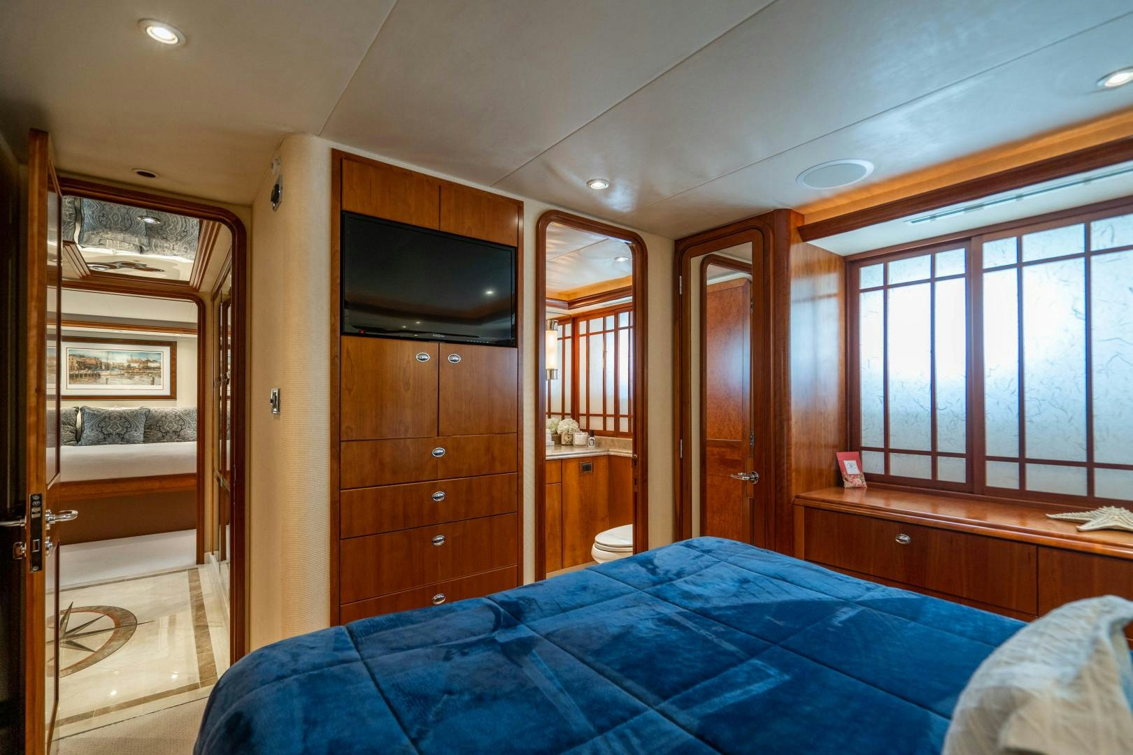 a bedroom with a bed and a tv aboard LEGACY Yacht for Sale