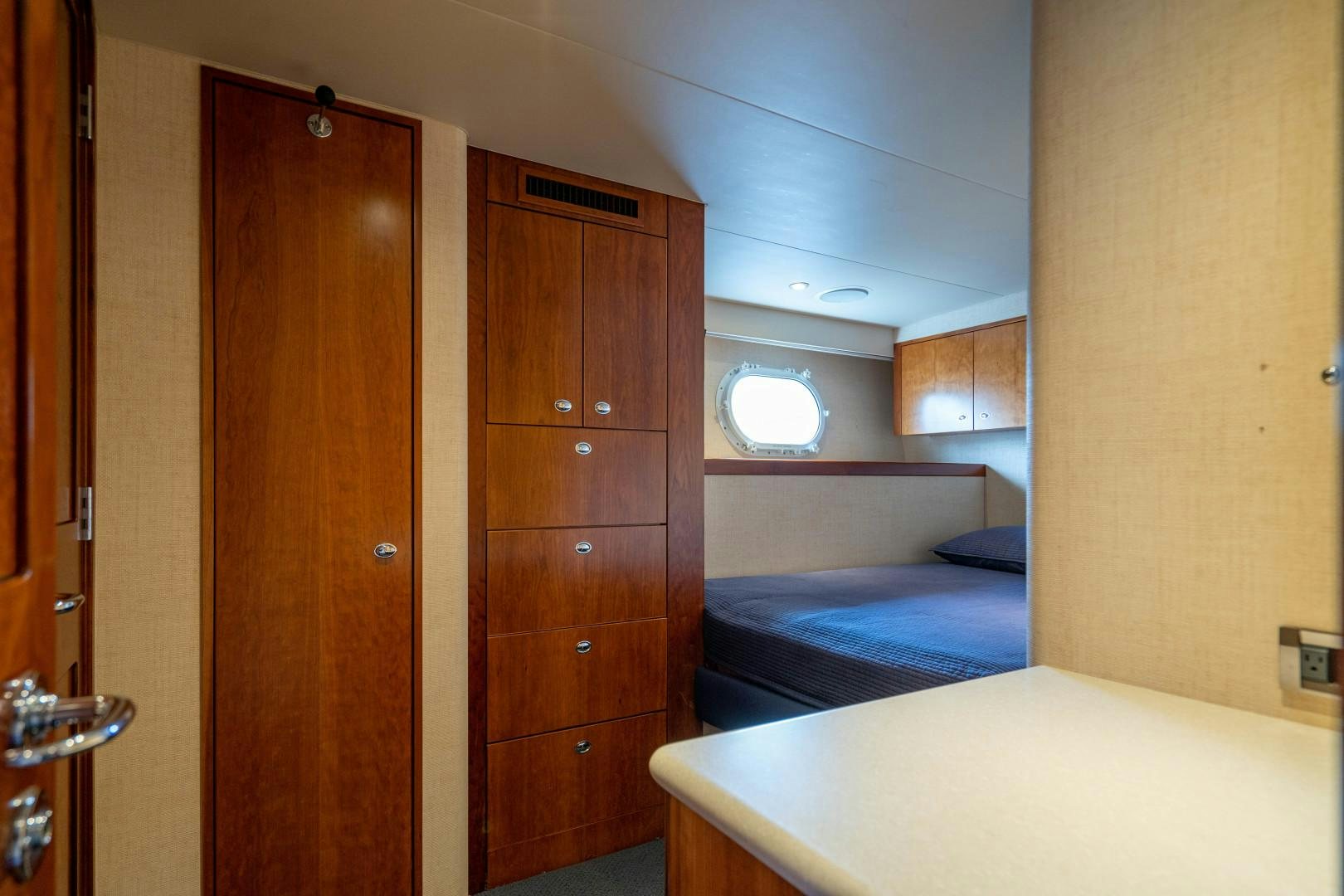 a room with a bed and a closet aboard LEGACY Yacht for Sale