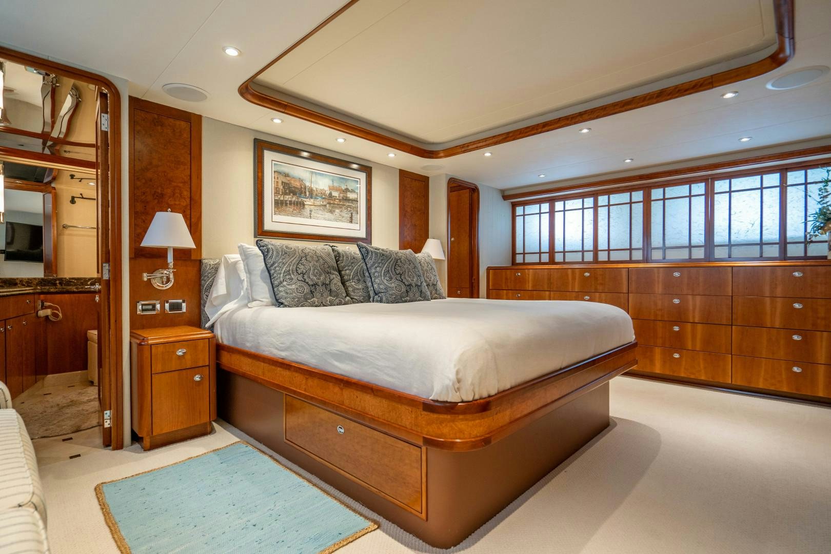 a bedroom with a bed and a large window aboard LEGACY Yacht for Sale