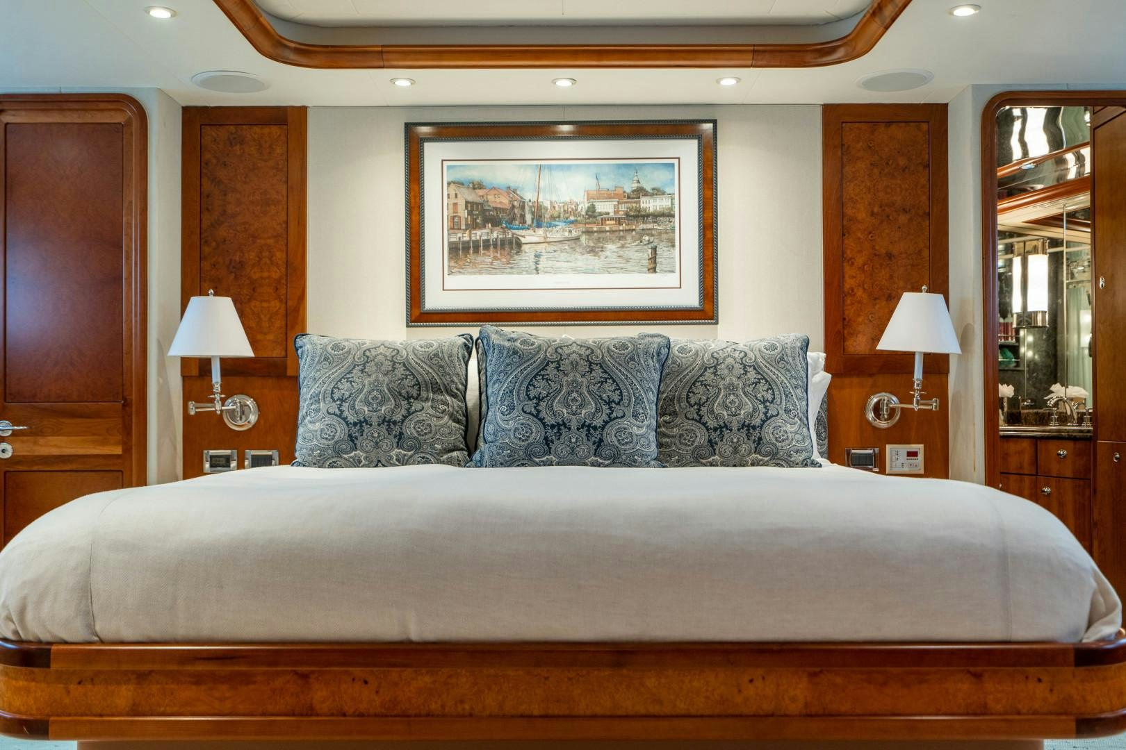 a bed with a white bed spread aboard LEGACY Yacht for Sale