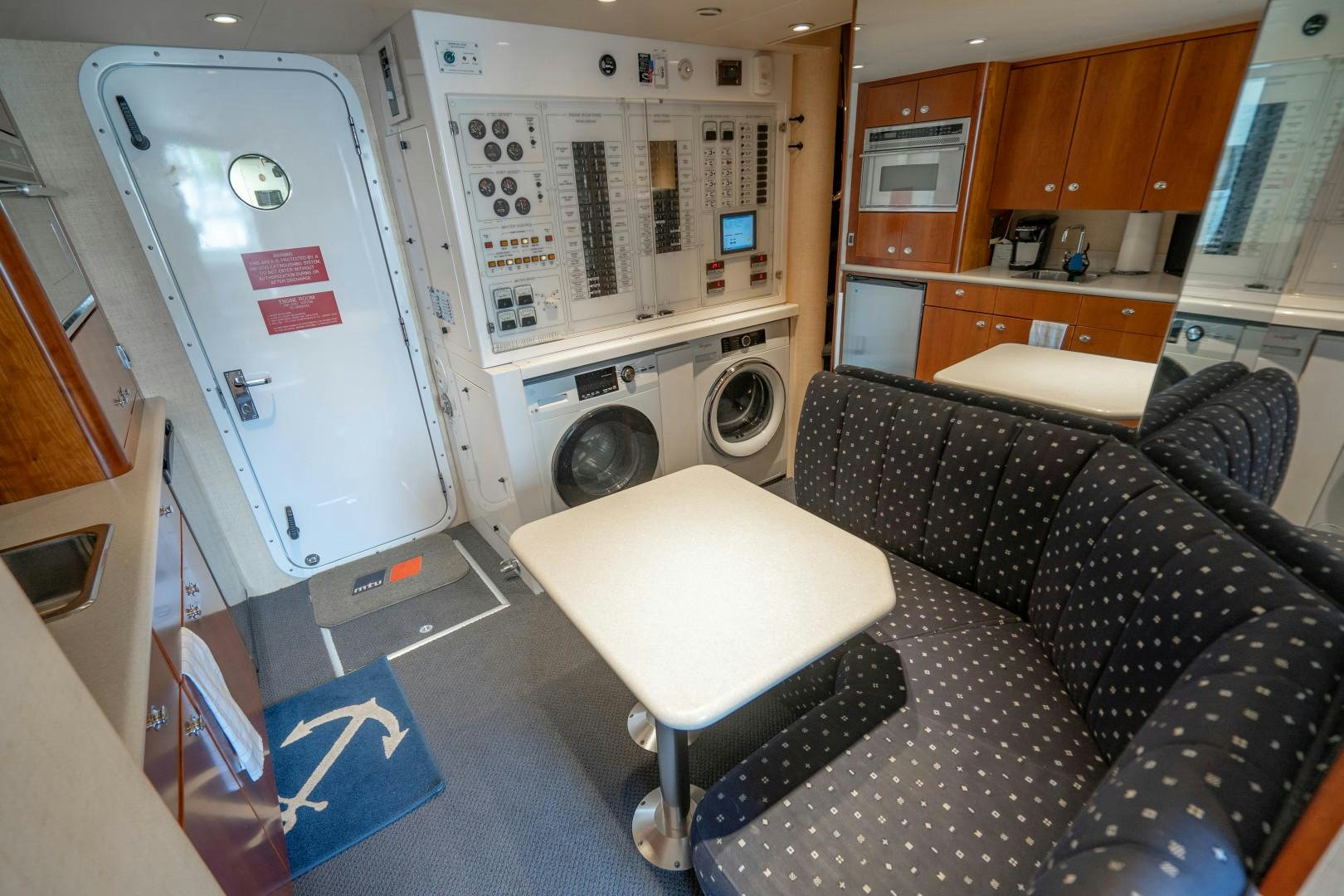 a room with a couch and a washing machine aboard LEGACY Yacht for Sale