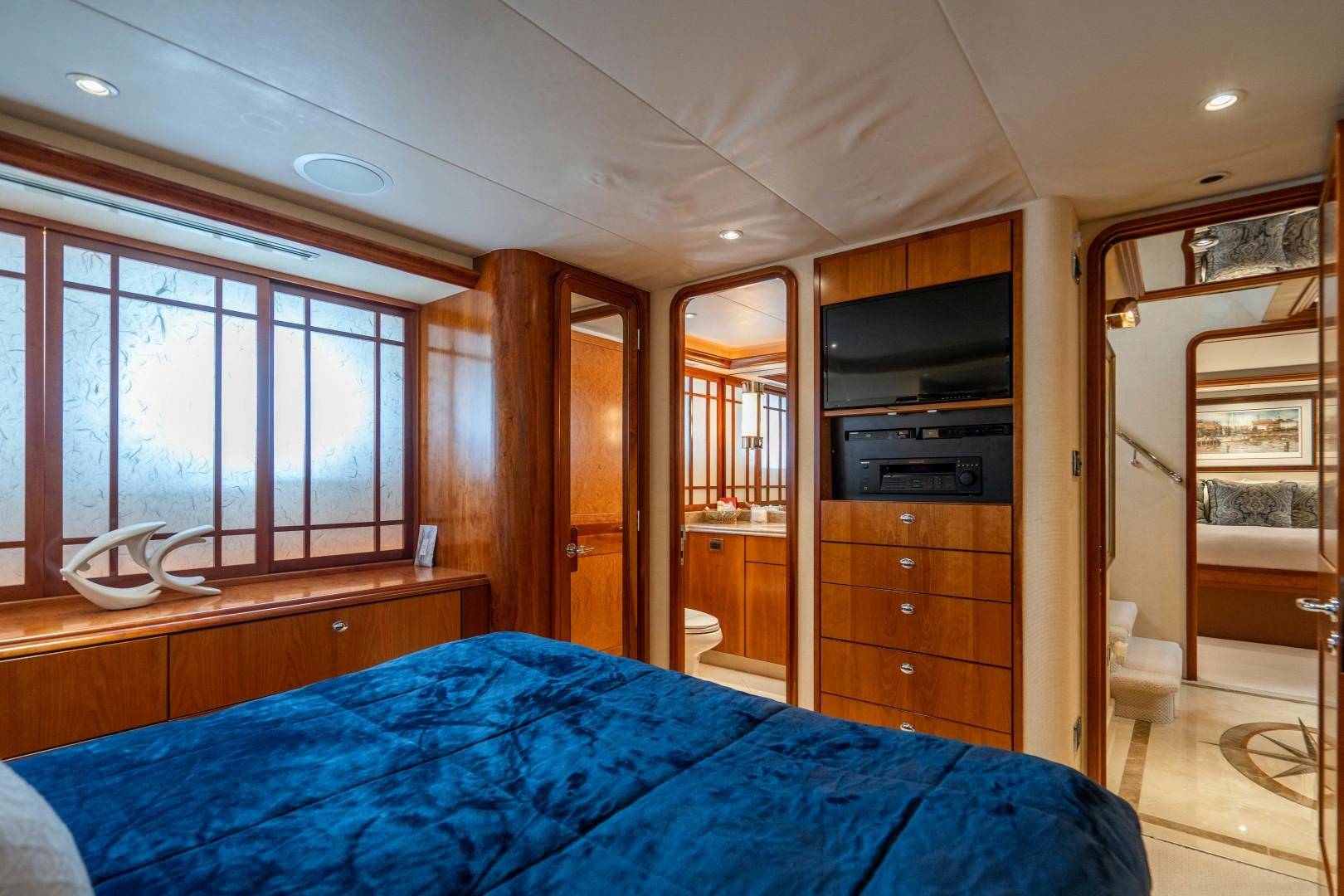 a bedroom with a bed and a television aboard LEGACY Yacht for Sale
