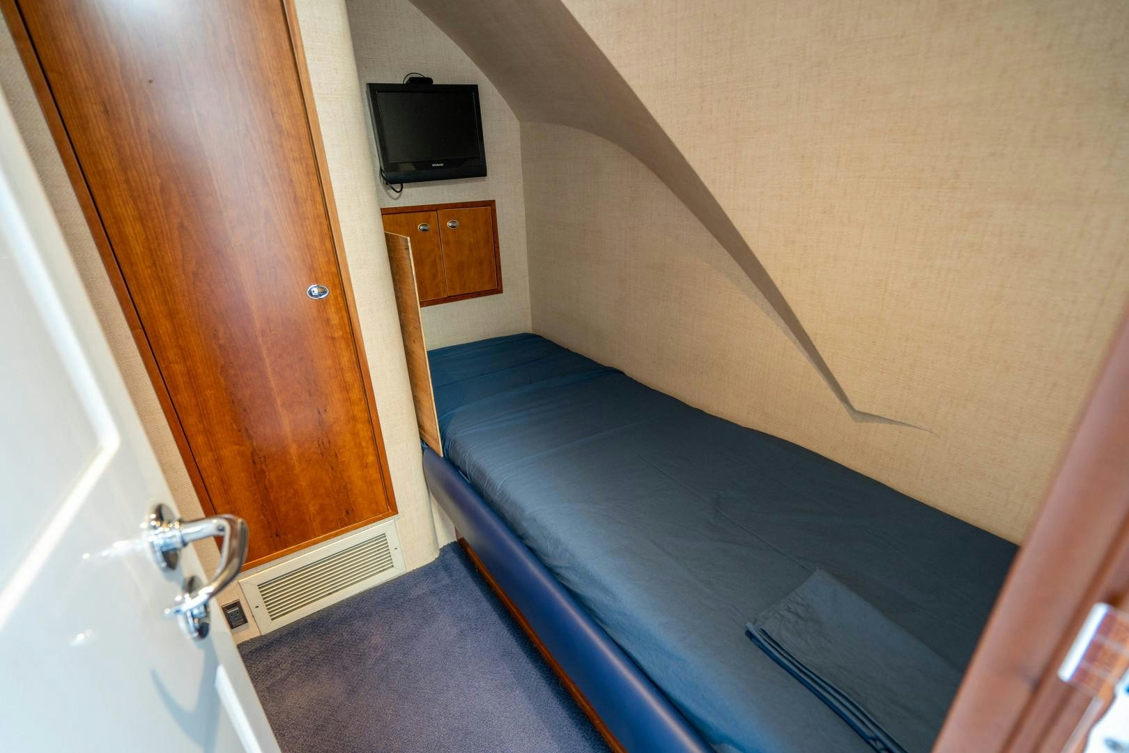 a room with a bed and a television aboard LEGACY Yacht for Sale