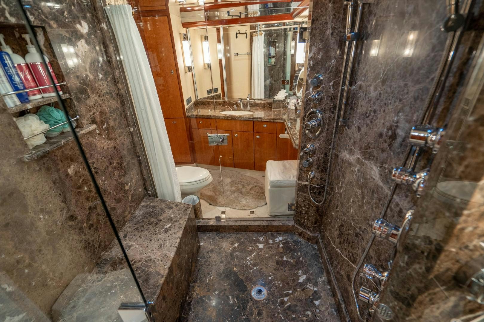 a bathroom with a glass shower aboard LEGACY Yacht for Sale