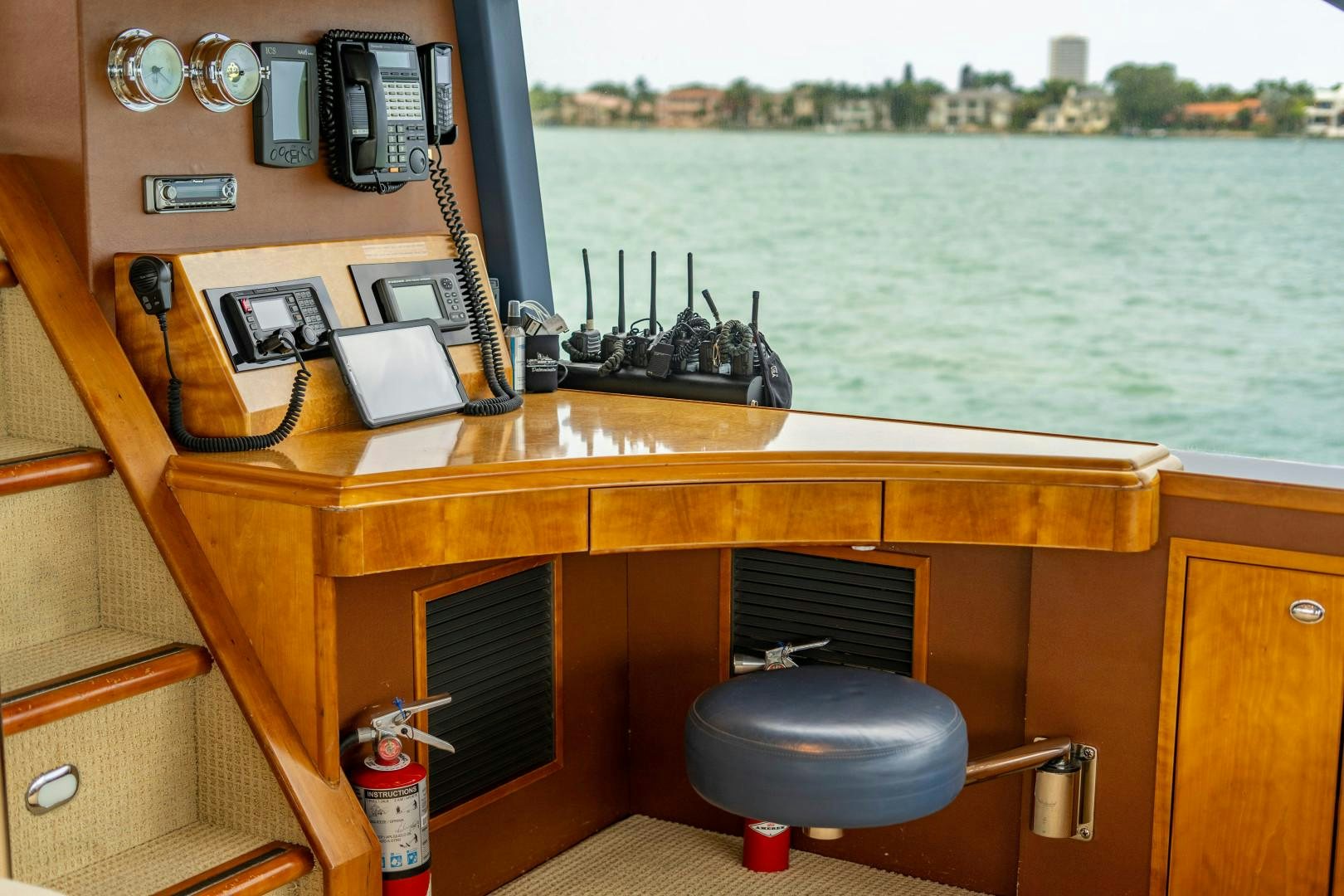 a desk with a computer and other office items on it aboard LEGACY Yacht for Sale