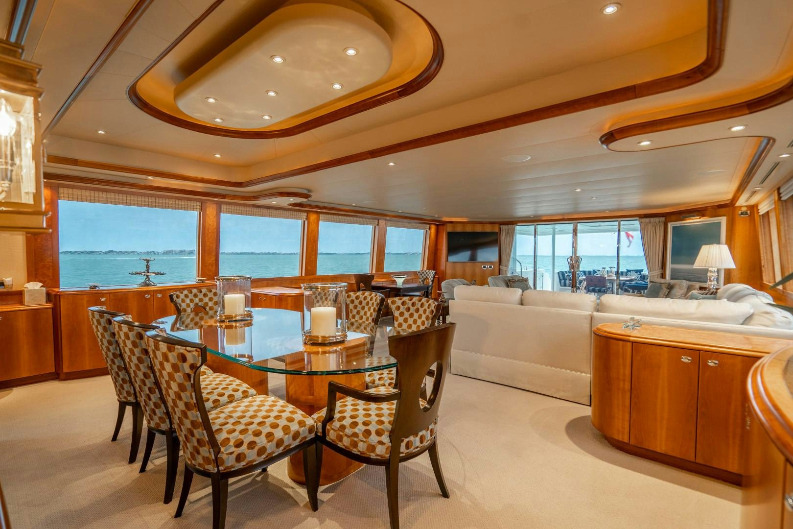 a large room with a table and chairs aboard LEGACY Yacht for Sale