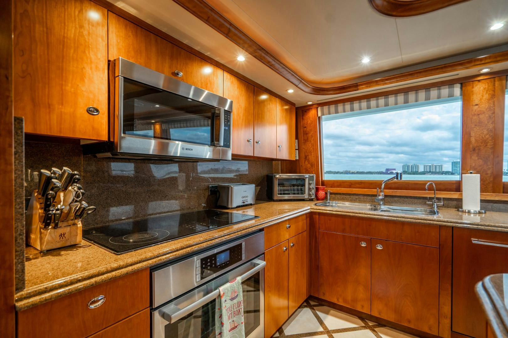 a kitchen with wooden cabinets aboard LEGACY Yacht for Sale