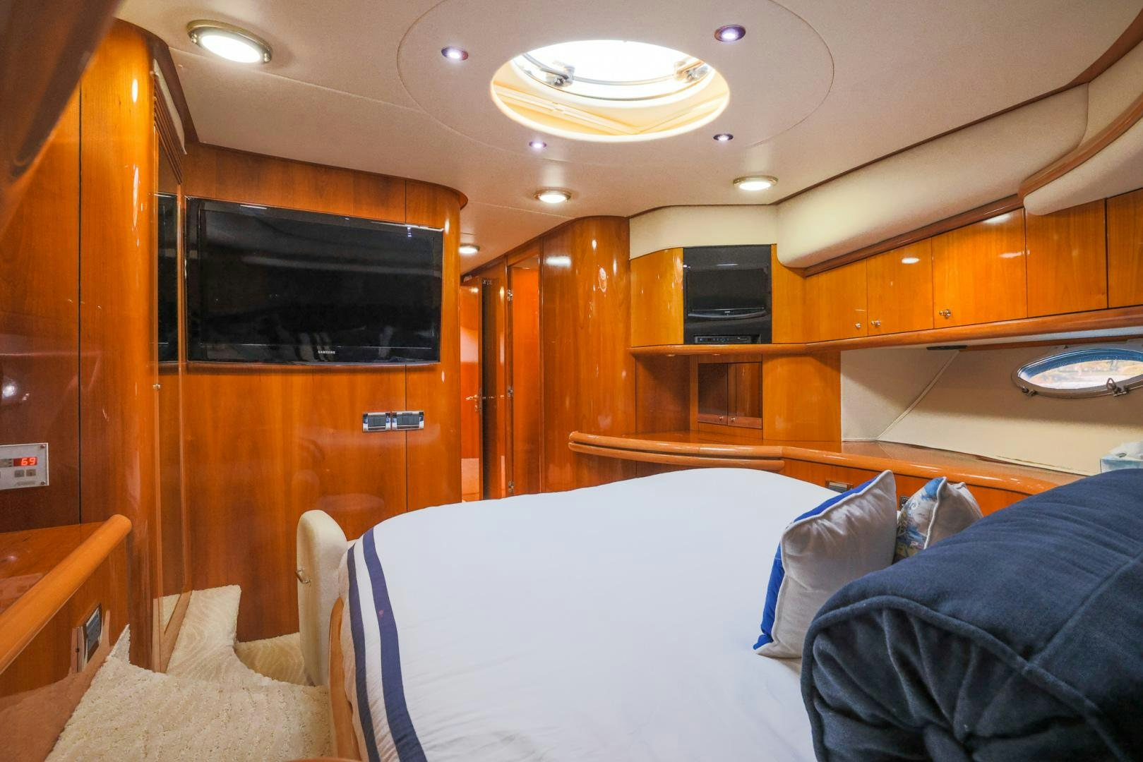 a room with a bed and a television aboard SIROCCO Yacht for Sale