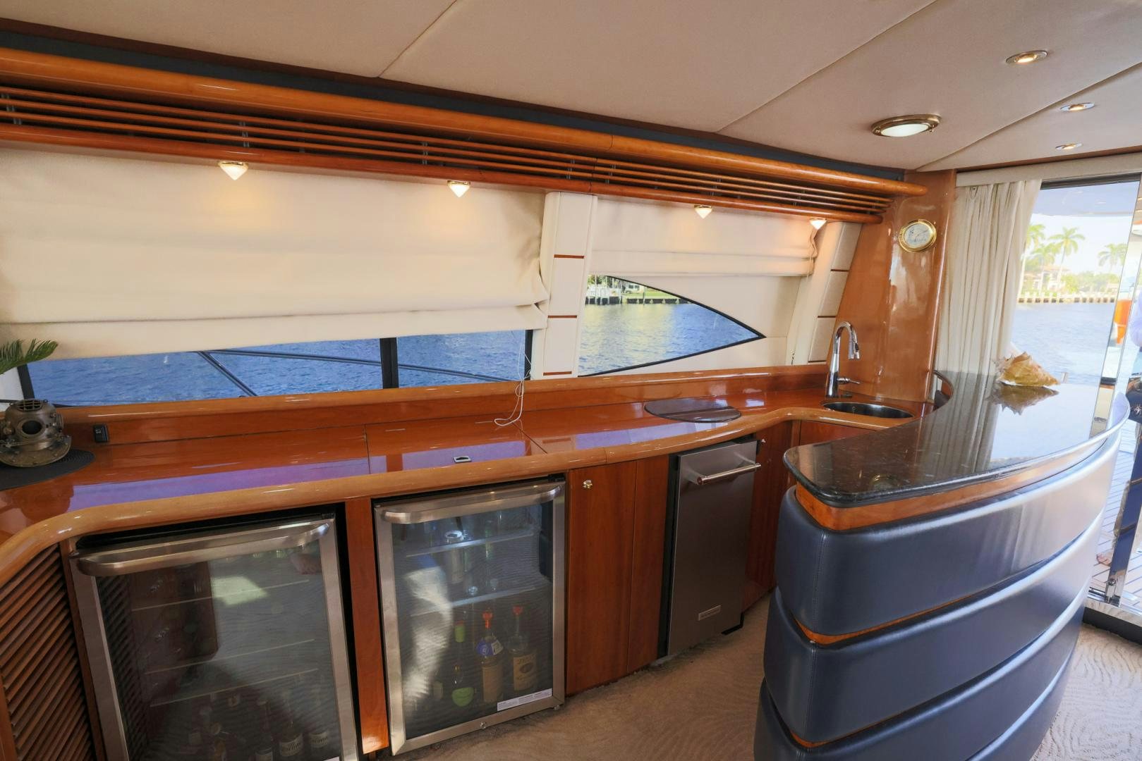 a kitchen with a bar and a large window aboard SIROCCO Yacht for Sale