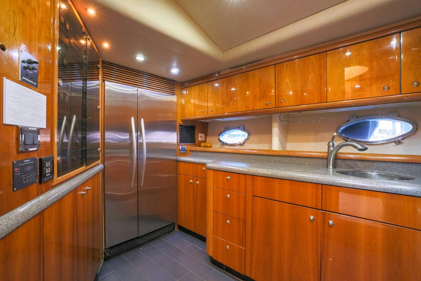 a kitchen with wooden cabinets aboard SIROCCO Yacht for Sale