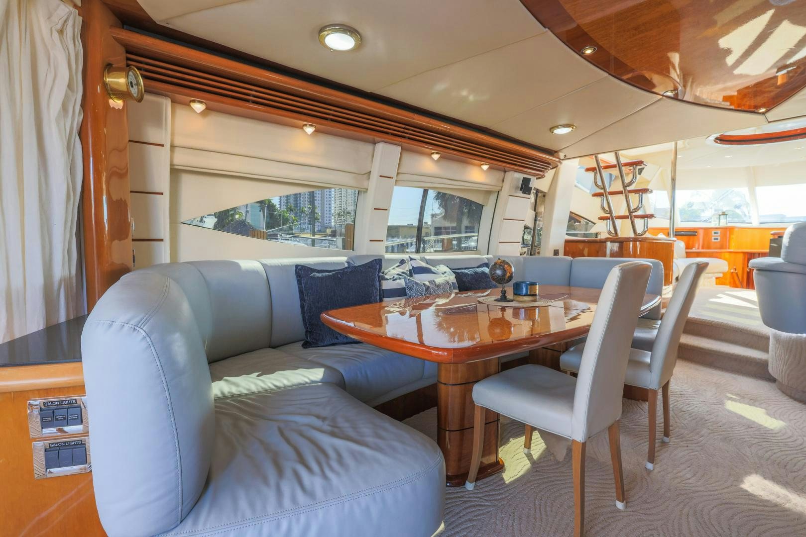 a living room with a table and chairs aboard SIROCCO Yacht for Sale