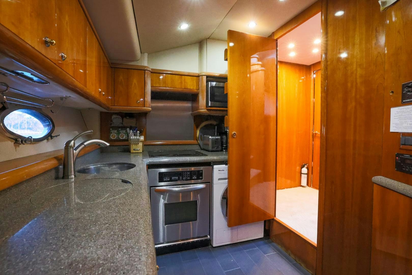 a kitchen with wooden cabinets aboard SIROCCO Yacht for Sale