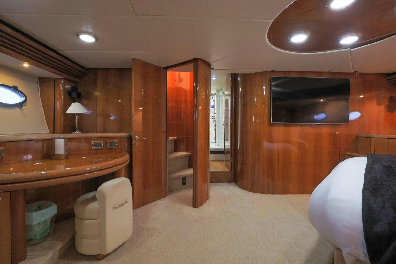 a room with a bed and desk aboard SIROCCO Yacht for Sale