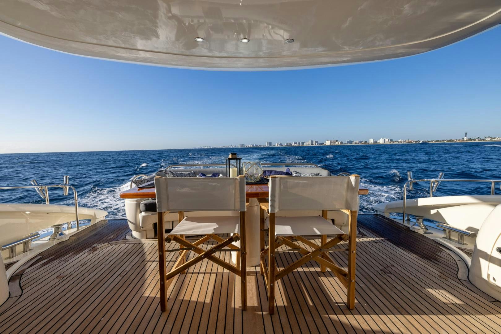 chairs on a deck overlooking a body of water aboard SIROCCO Yacht for Sale