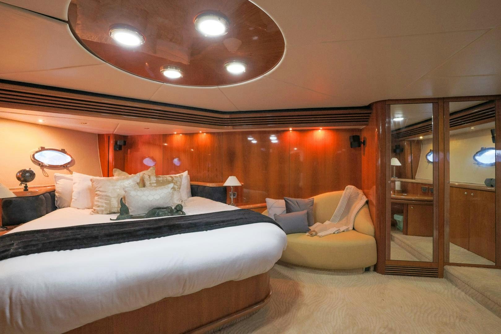 a room with a bed and a couch aboard SIROCCO Yacht for Sale