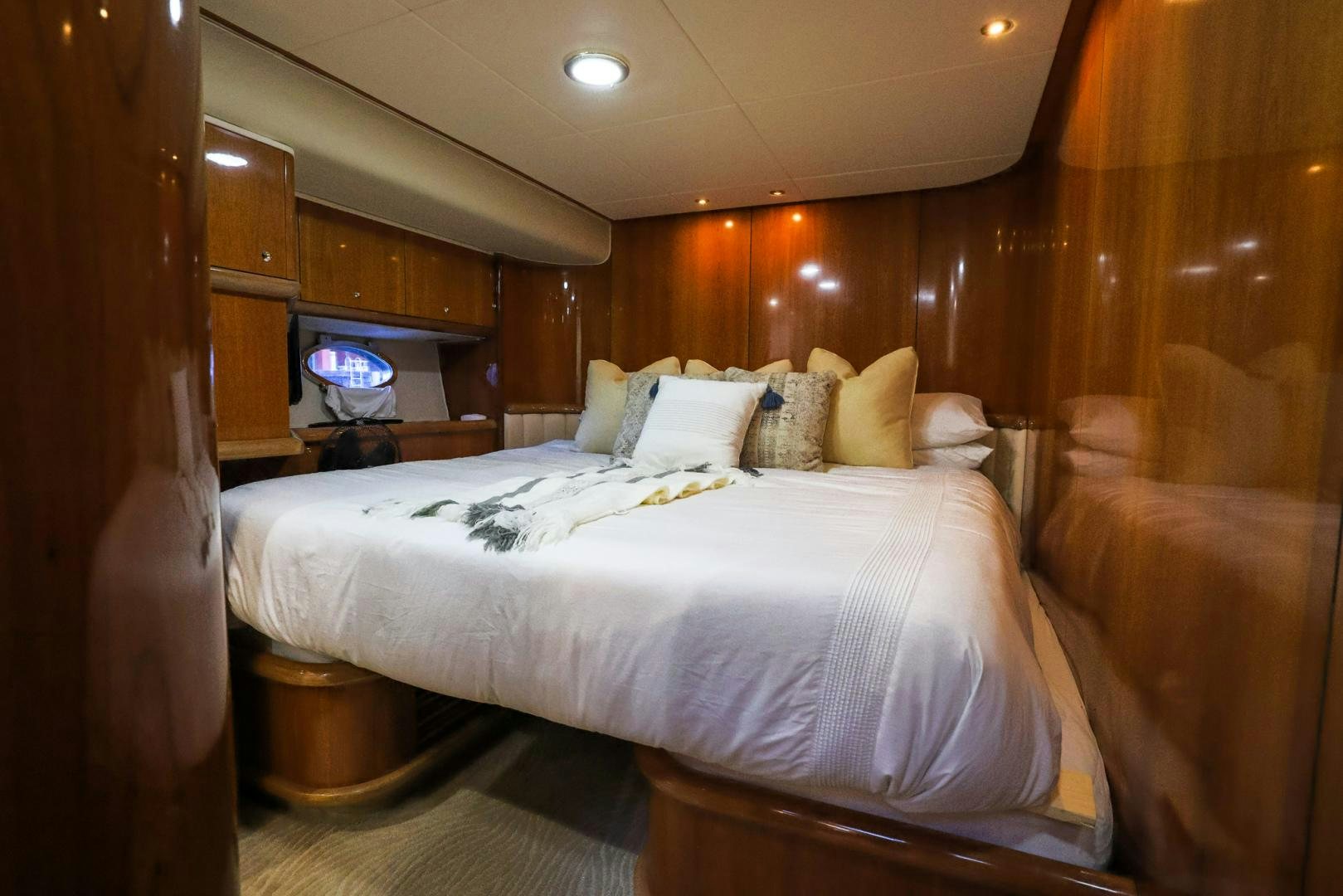 a bed with a television on the wall aboard SIROCCO Yacht for Sale