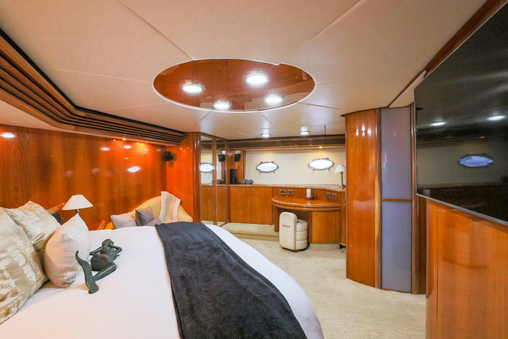 a bedroom with a bed and a desk aboard SIROCCO Yacht for Sale