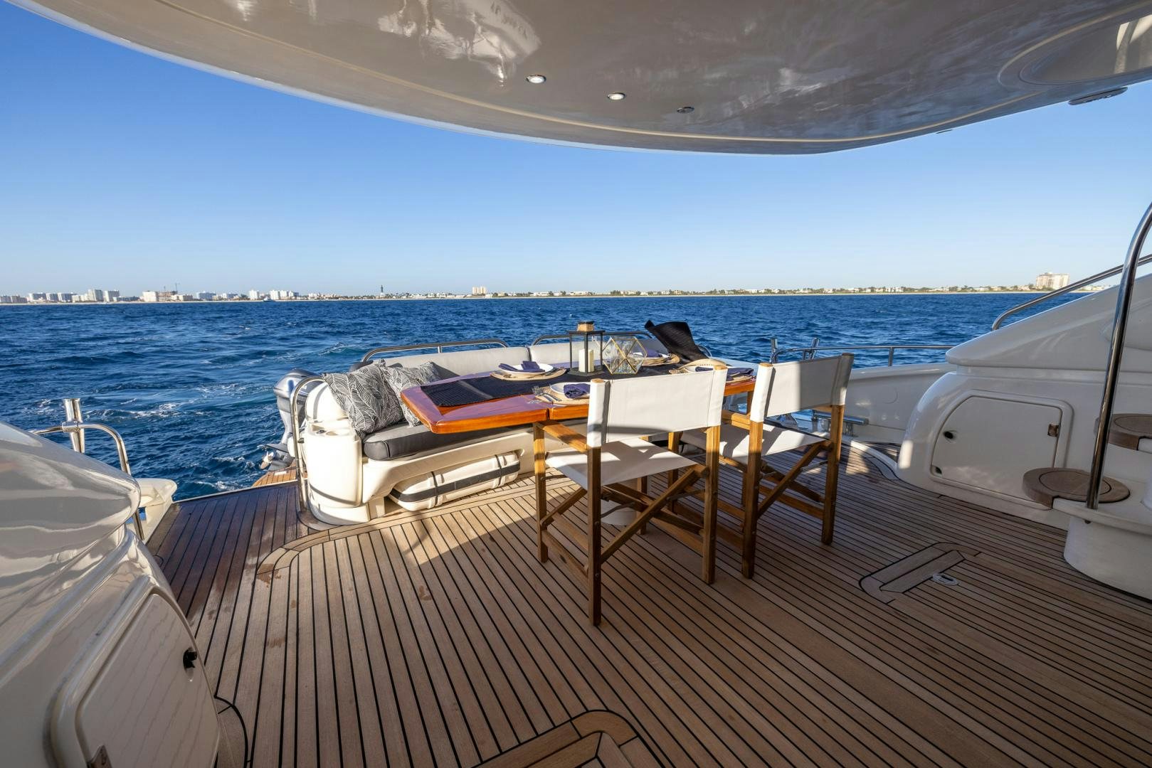 a deck with a table and chairs on it aboard SIROCCO Yacht for Sale