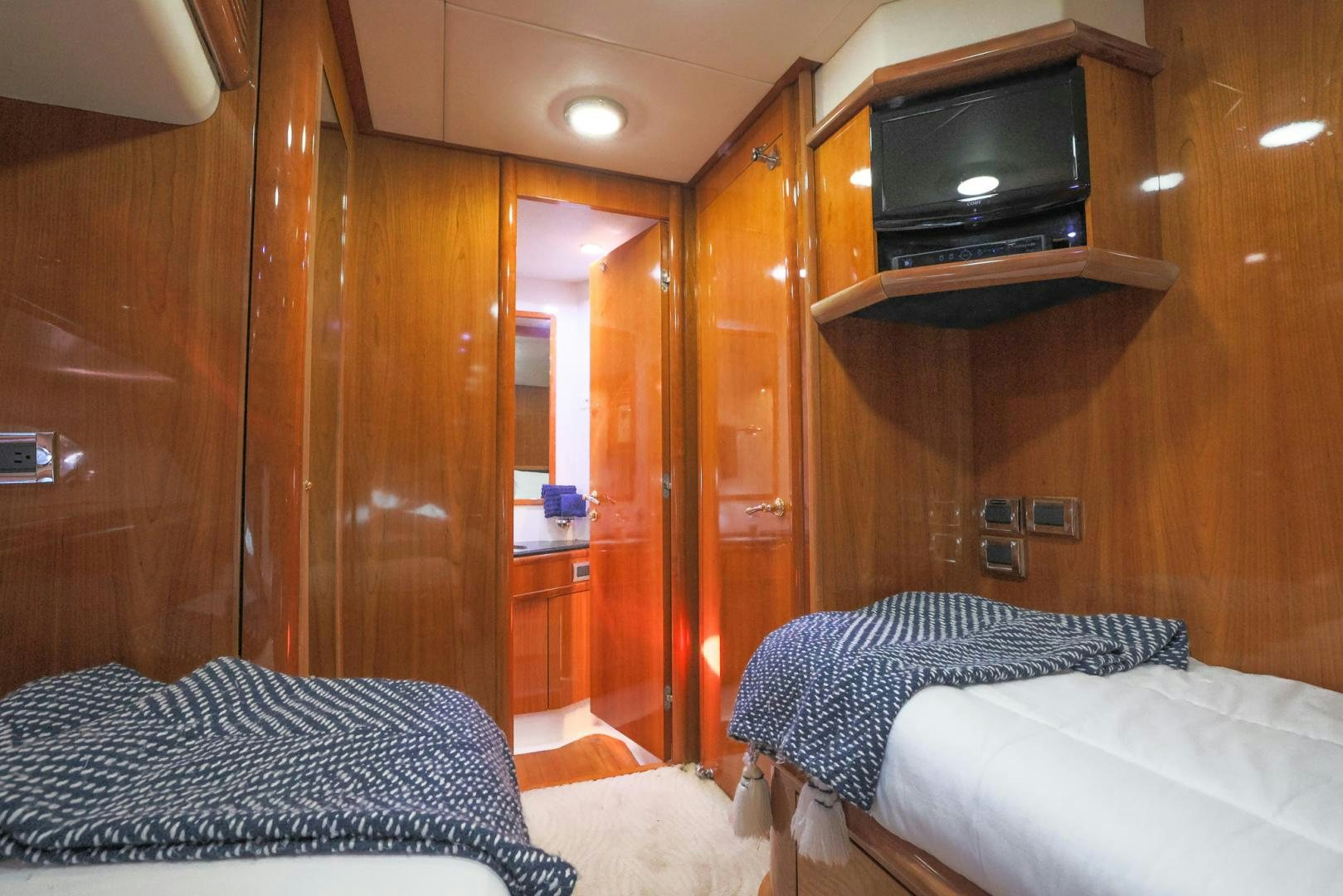 a bedroom with a tv and a bed aboard SIROCCO Yacht for Sale