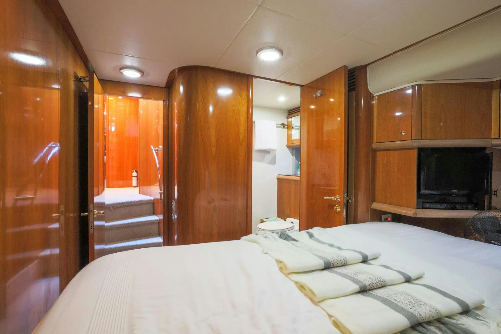 a room with a bed and a television aboard SIROCCO Yacht for Sale