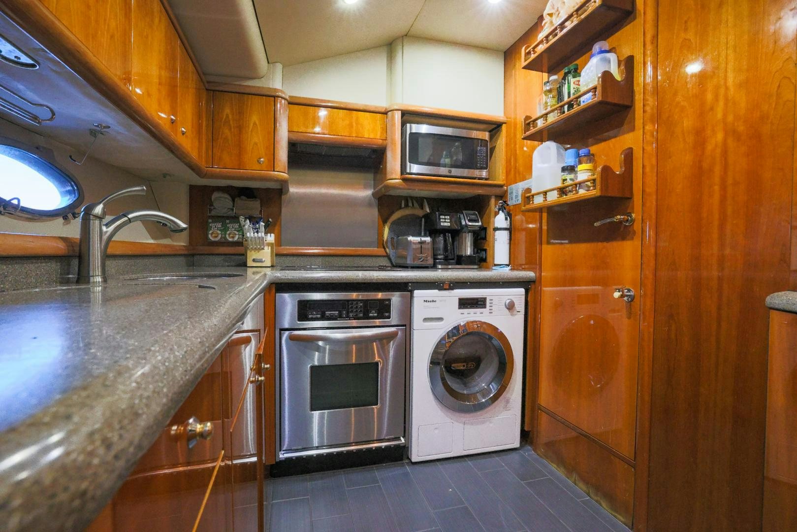 a kitchen with wooden cabinets aboard SIROCCO Yacht for Sale
