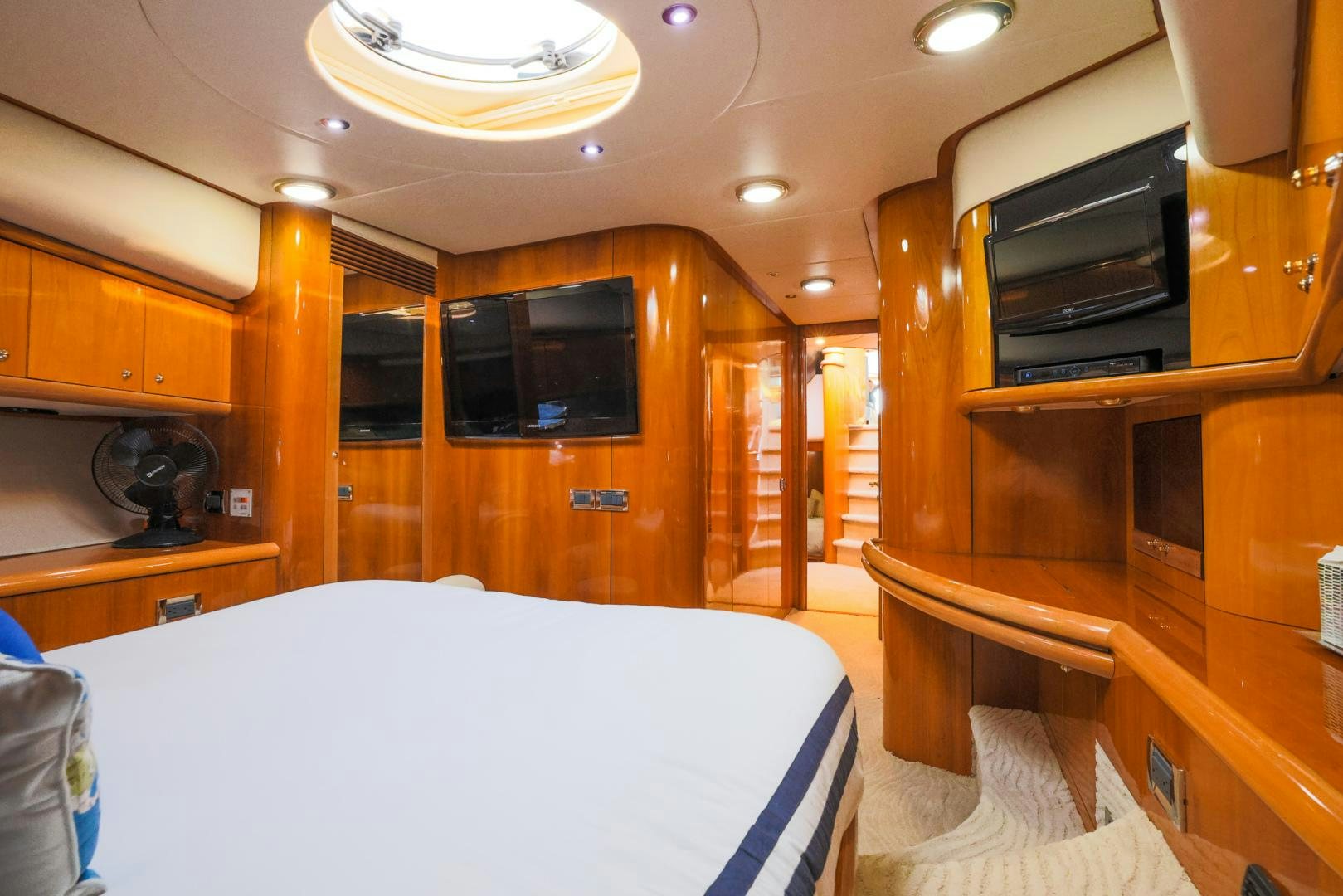 a room with a bed and a television aboard SIROCCO Yacht for Sale