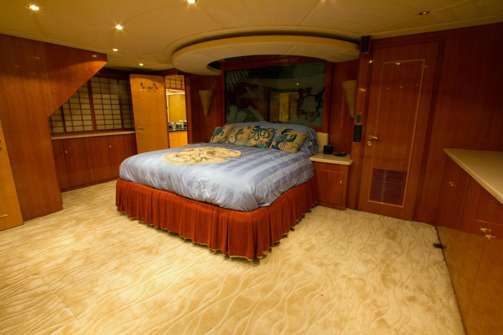 a bedroom with a bed and a wood door aboard GLEN ELLEN Yacht for Sale