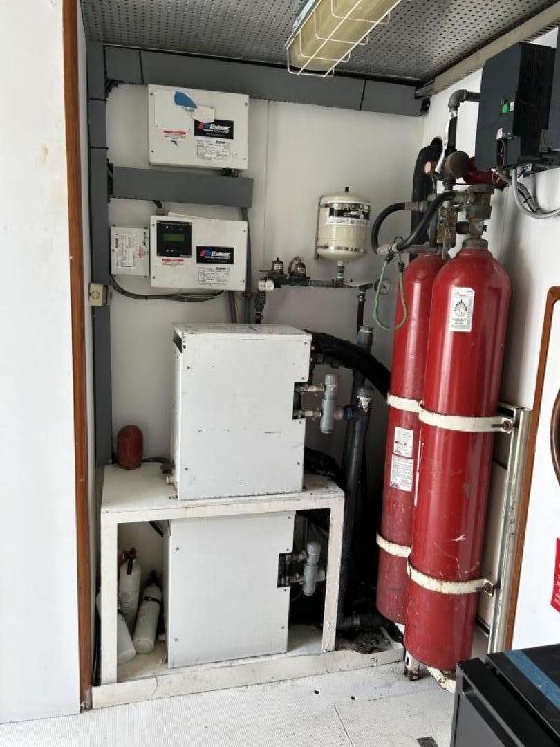 a red fire extinguisher in a room aboard GLEN ELLEN Yacht for Sale