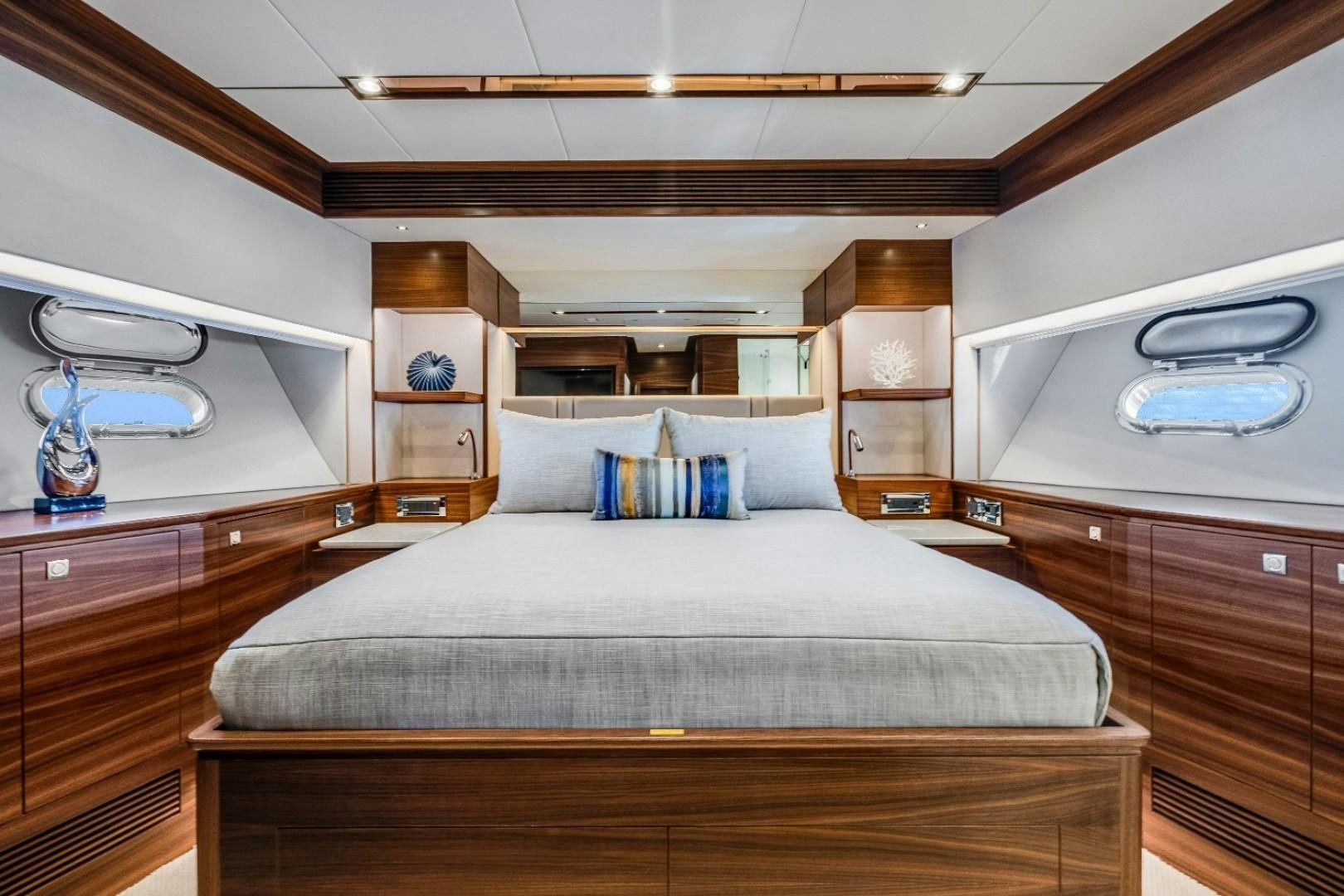 a bedroom with a bed and a dresser aboard TI AMO Yacht for Sale