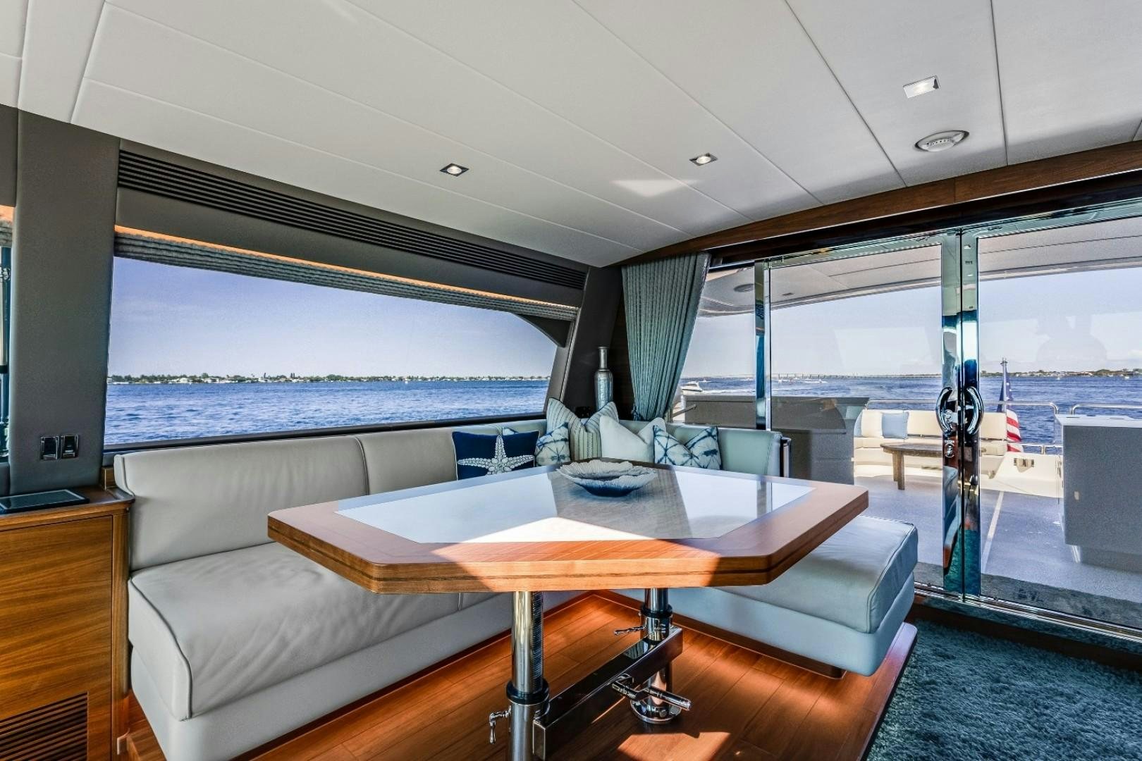 a room with a table and a couch aboard TI AMO Yacht for Sale