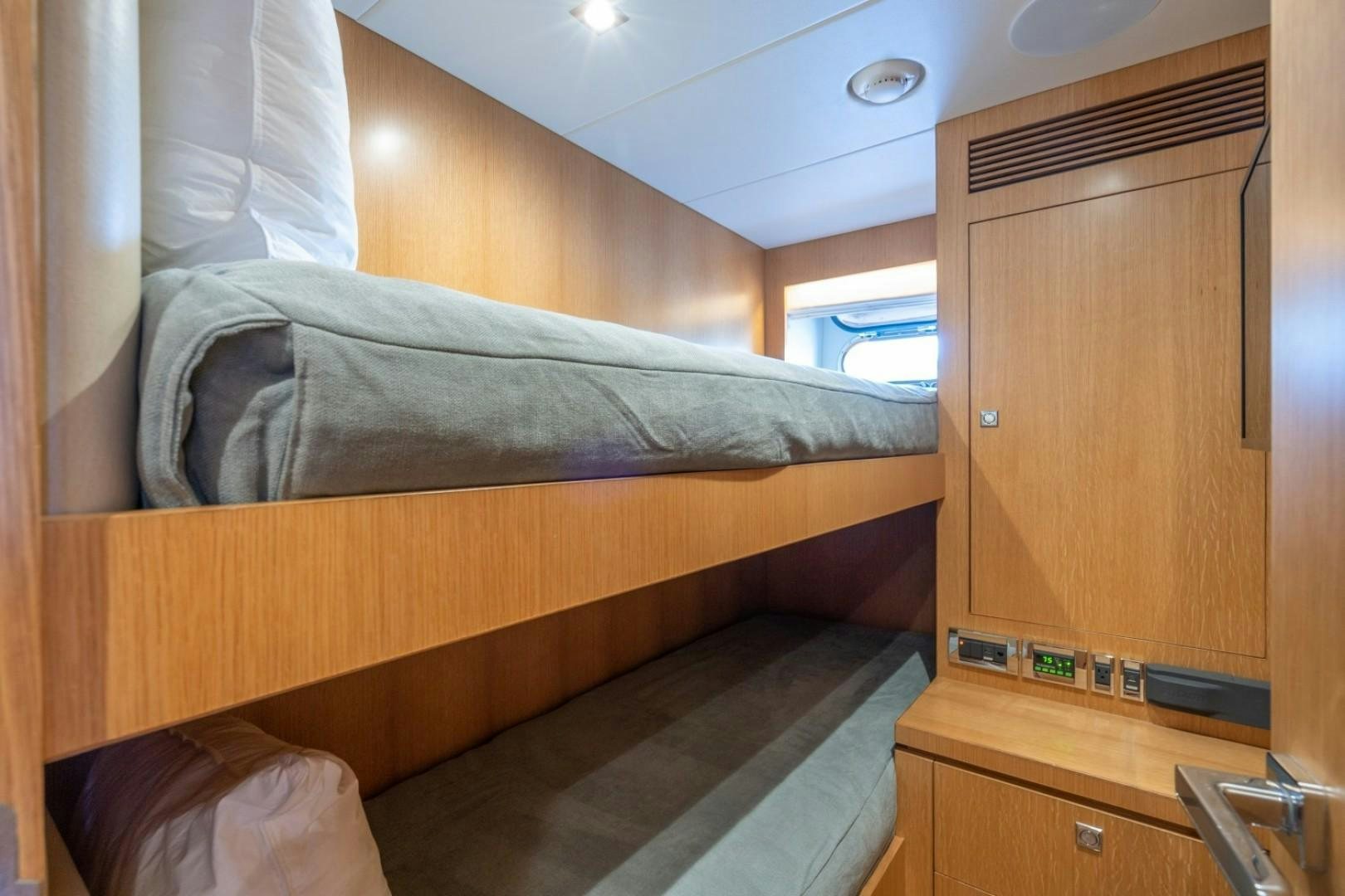 a bed with a wooden headboard aboard TI AMO Yacht for Sale