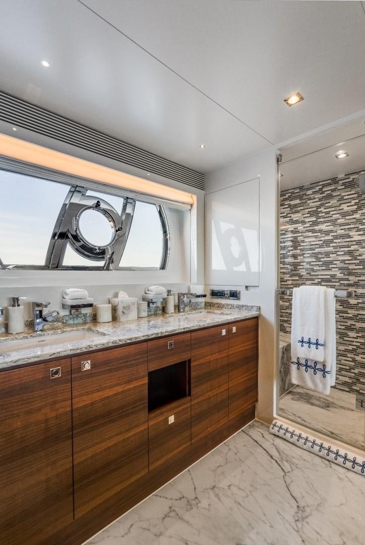 a bathroom with a large mirror aboard TI AMO Yacht for Sale