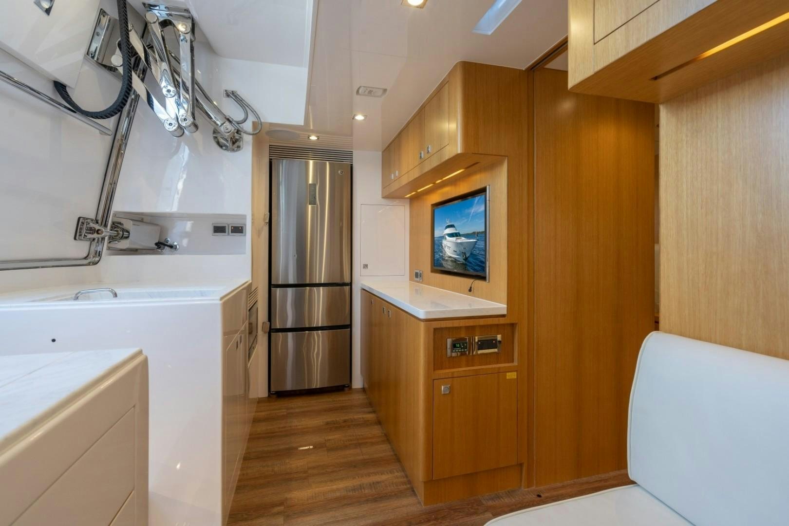 a room with a tv and a fridge aboard TI AMO Yacht for Sale