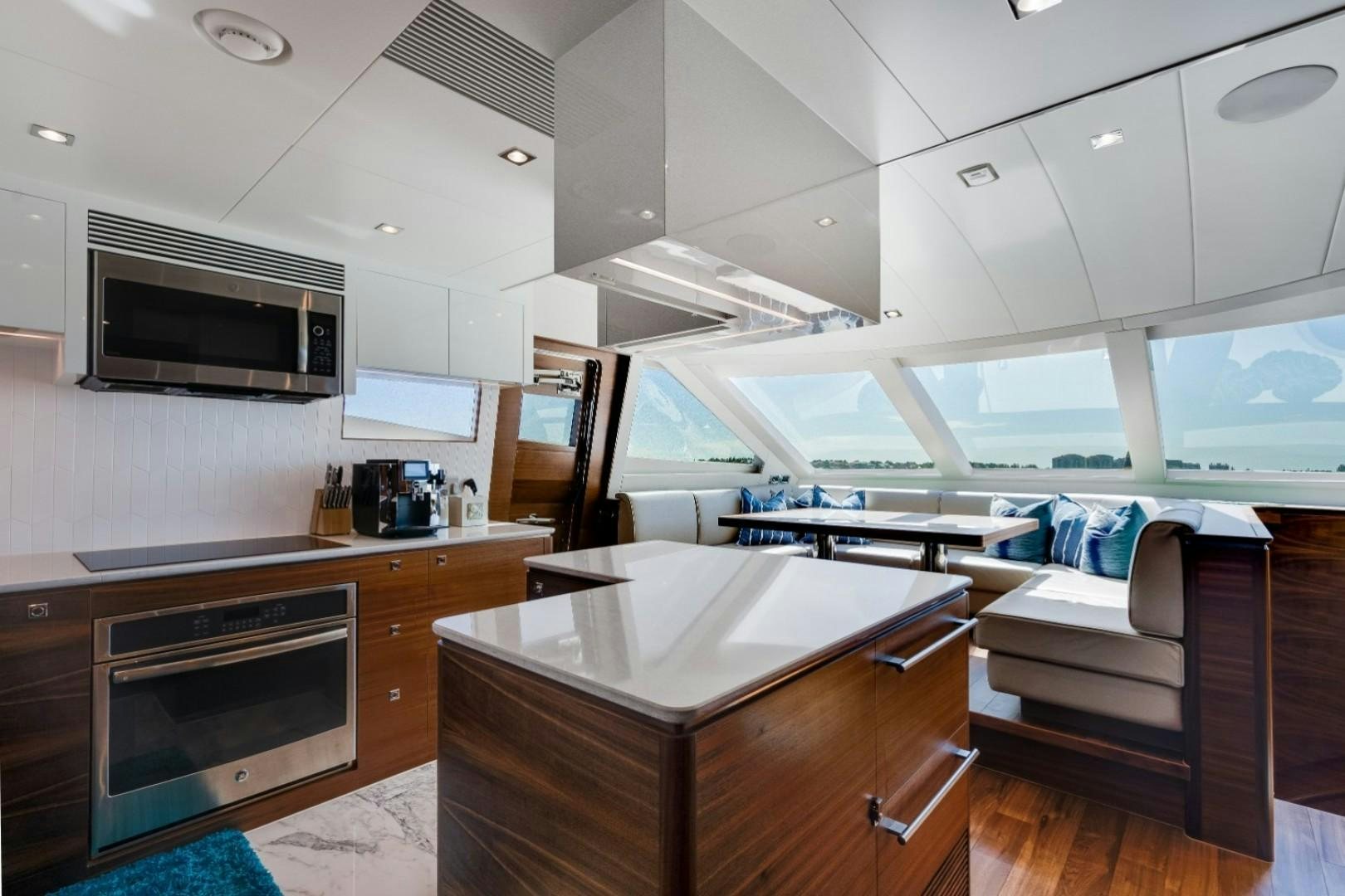 a kitchen with a couch and a microwave aboard TI AMO Yacht for Sale