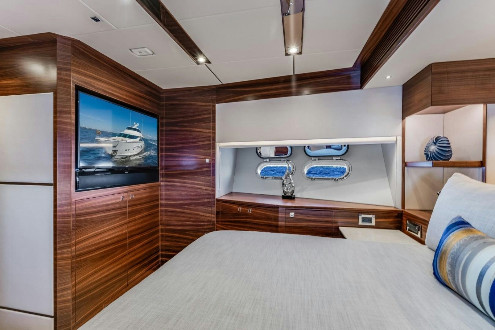 a bedroom with a bed and a television aboard TI AMO Yacht for Sale