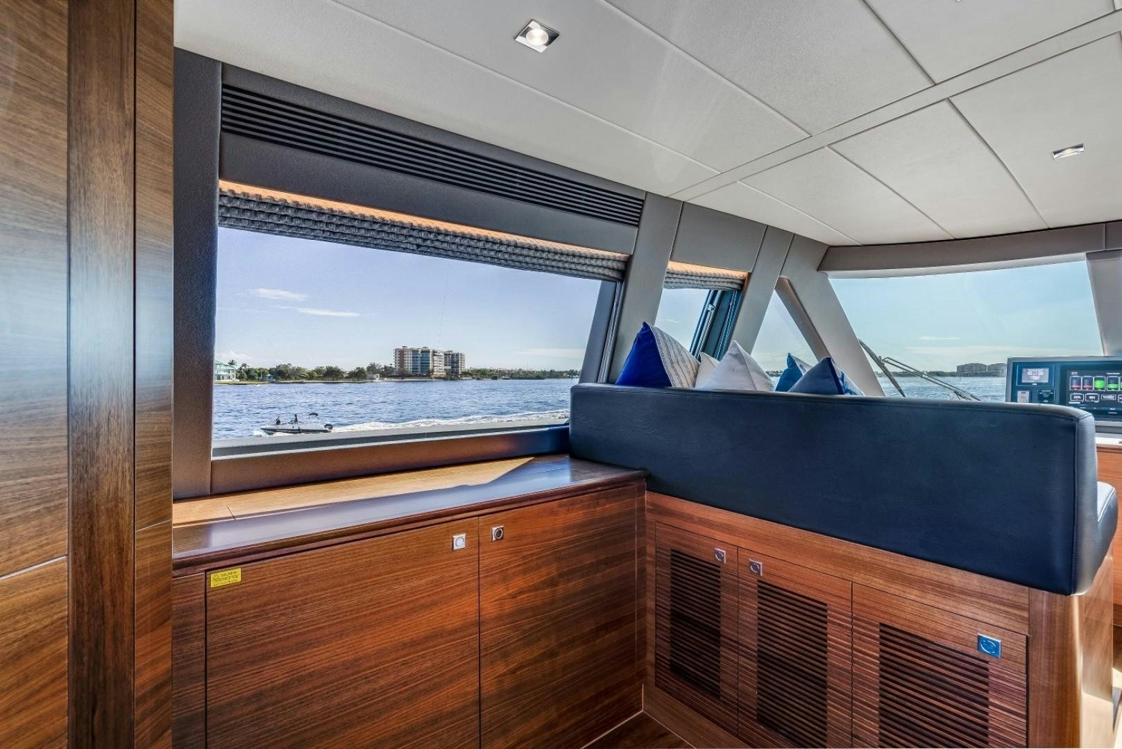 a room with a window and a view of a city aboard TI AMO Yacht for Sale