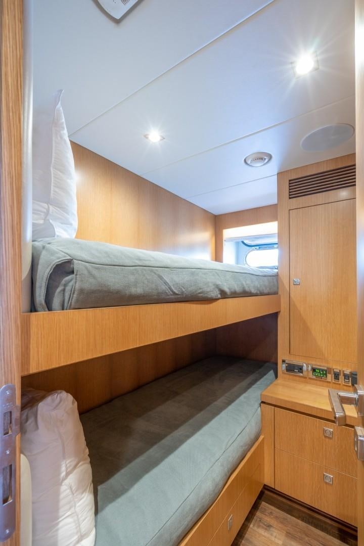 a room with a bed and a dresser aboard TI AMO Yacht for Sale