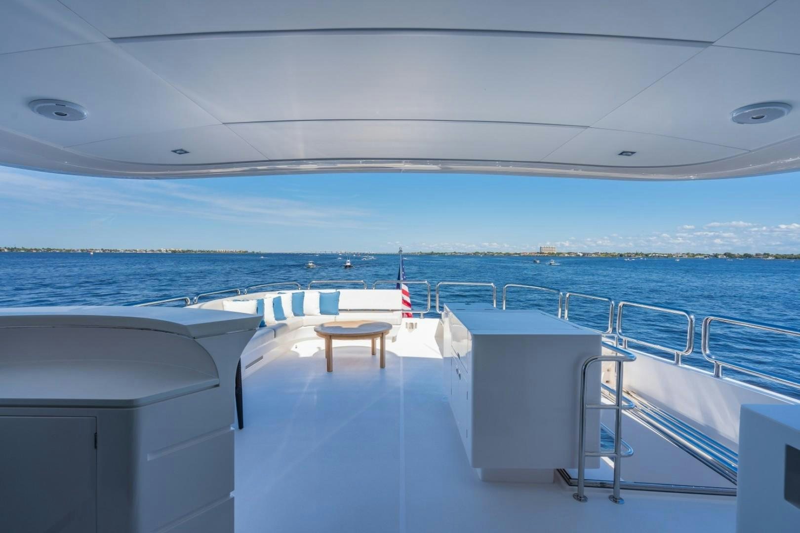 a deck with chairs and tables on it by the water aboard TI AMO Yacht for Sale