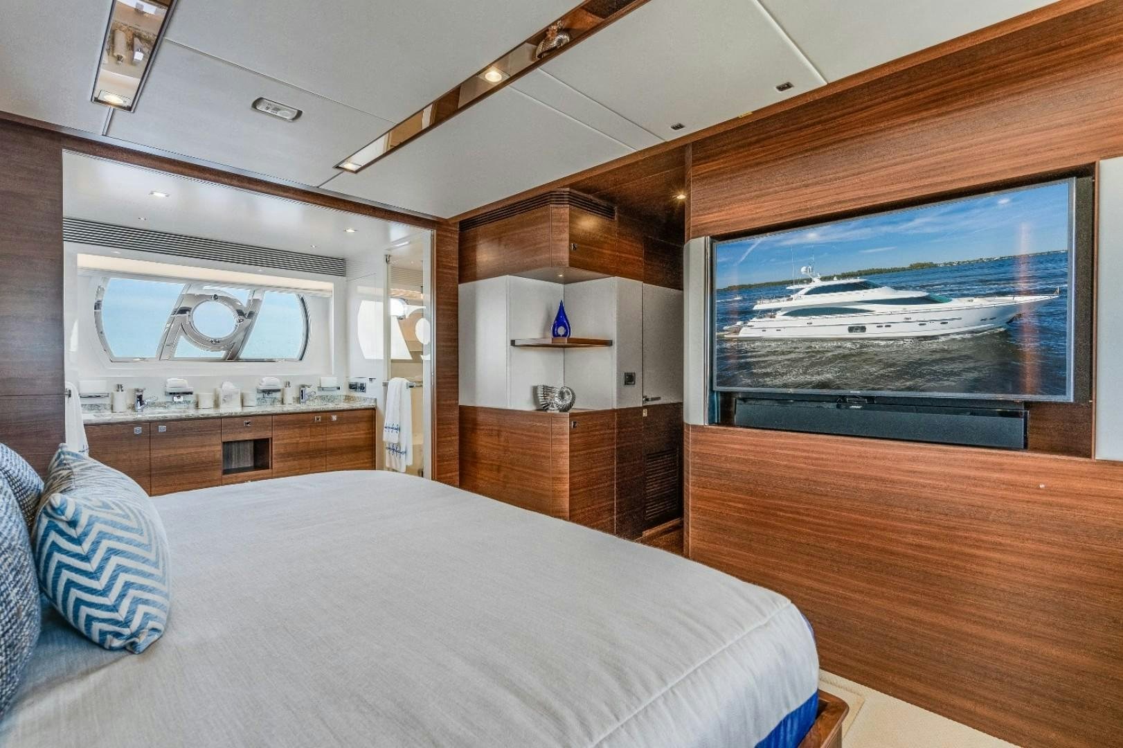 a bedroom with a large television aboard TI AMO Yacht for Sale