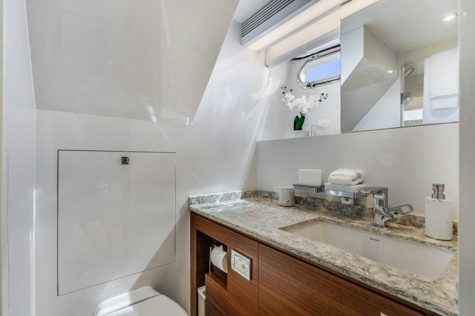 a bathroom with a sink and a toilet aboard TI AMO Yacht for Sale