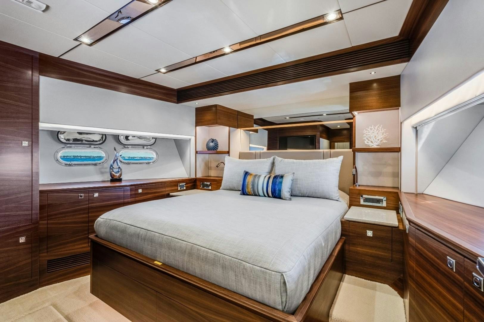 a bedroom with a bed and a wood floor aboard TI AMO Yacht for Sale