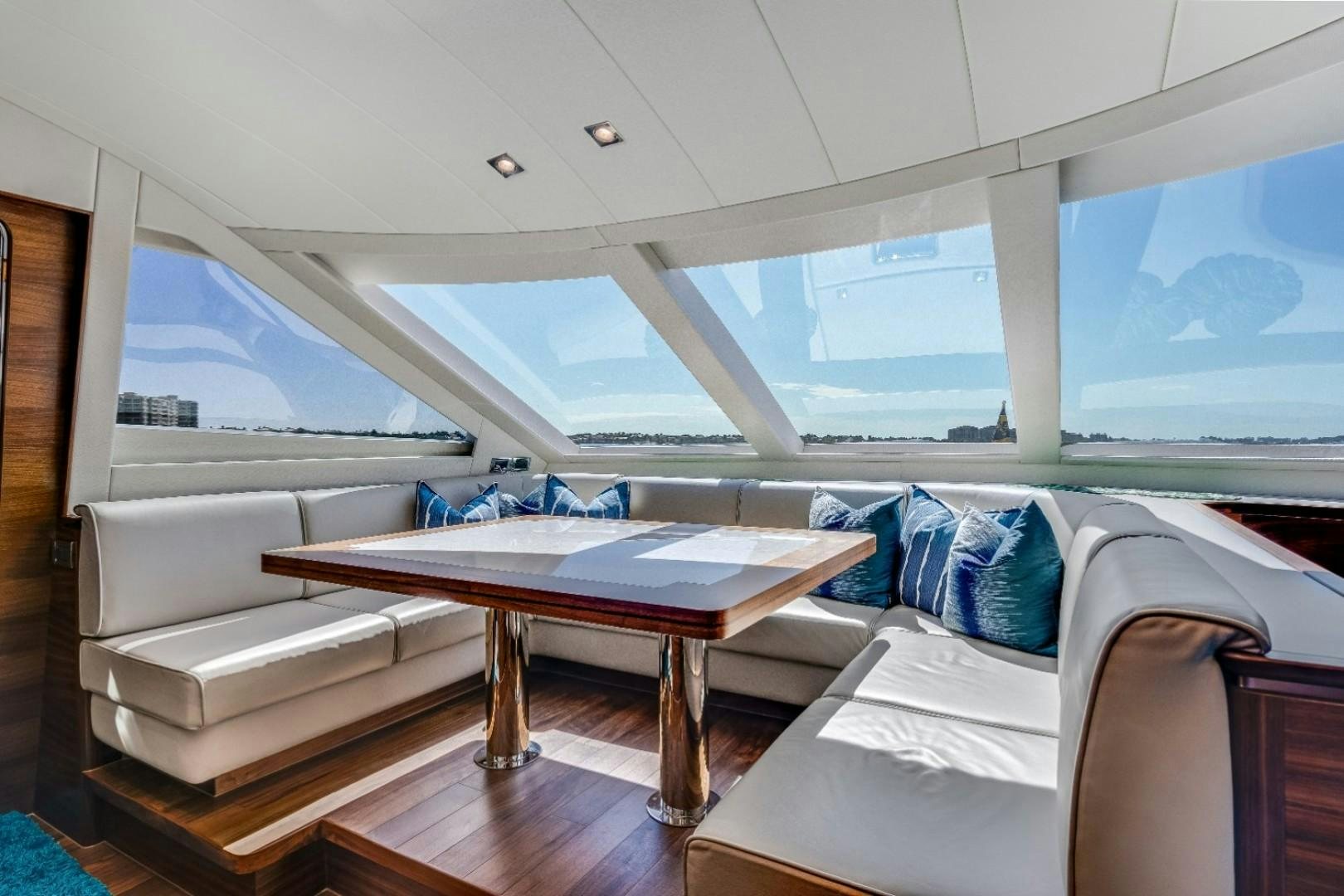 a room with beds and a table aboard TI AMO Yacht for Sale