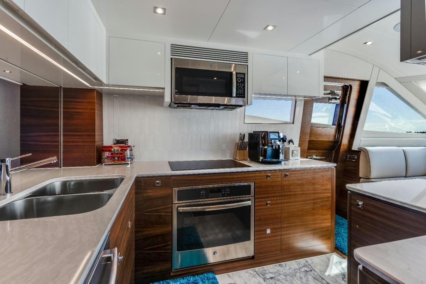 a kitchen with a stove and microwave aboard TI AMO Yacht for Sale