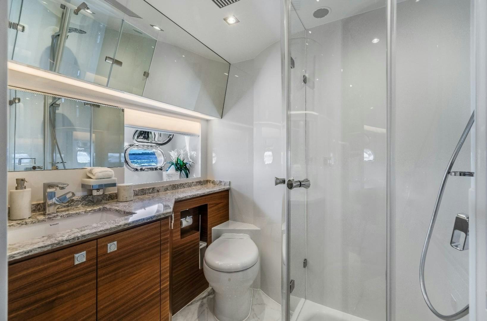 a bathroom with a glass shower aboard TI AMO Yacht for Sale