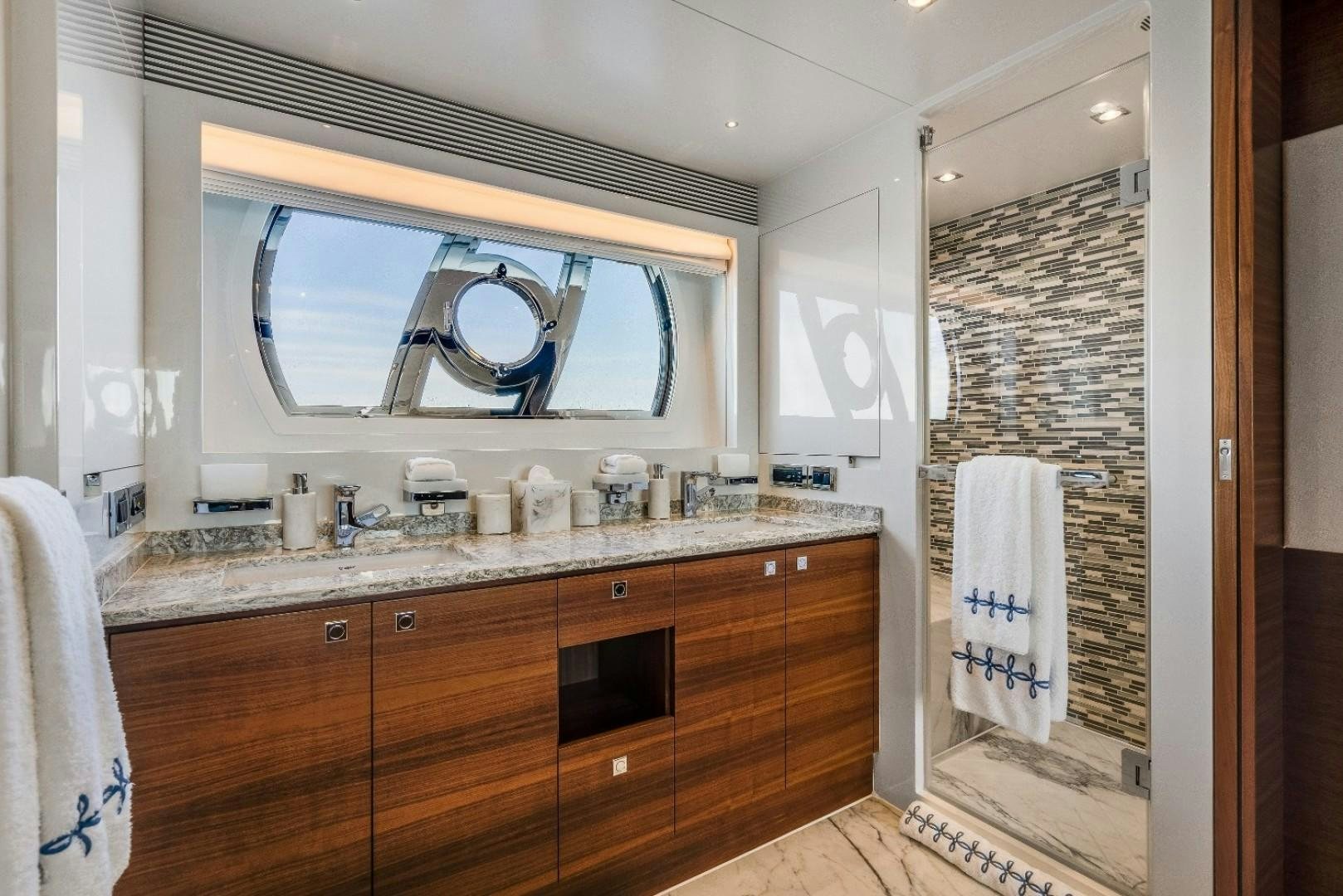 a bathroom with a sink and a mirror aboard TI AMO Yacht for Sale