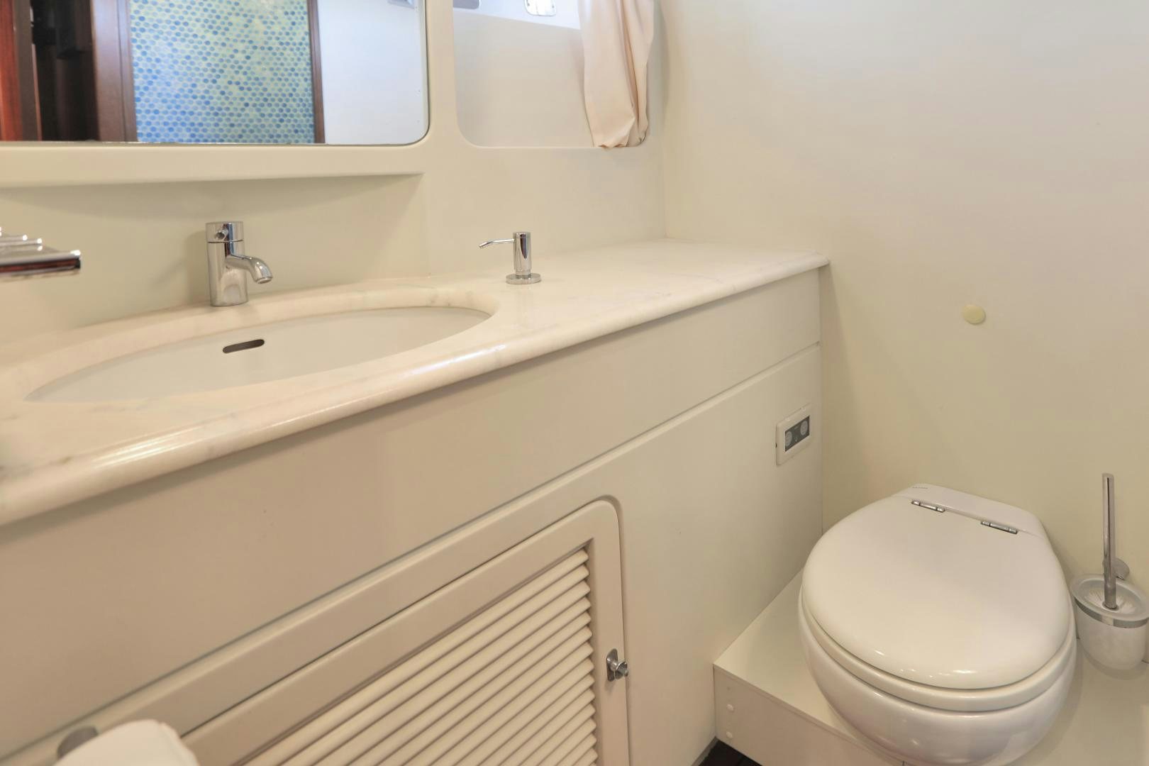 a bathroom with a toilet and sink aboard IRON MONKEY Yacht for Sale